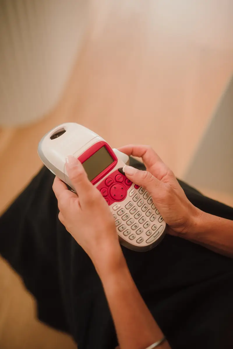 Close-up of a label maker being used to create storage labels